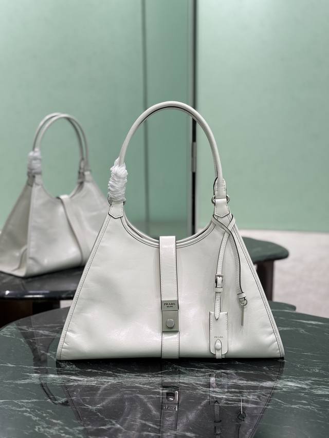 大号 春夏最新走秀款，几何线条与精致匠心细节，是这款柔美体量手袋的亮点所在。梯形廓形配以纤长手提柄，亦可作为单肩包轻松肩背。竖向锁扣的设计灵感源自档案库，皮革镜