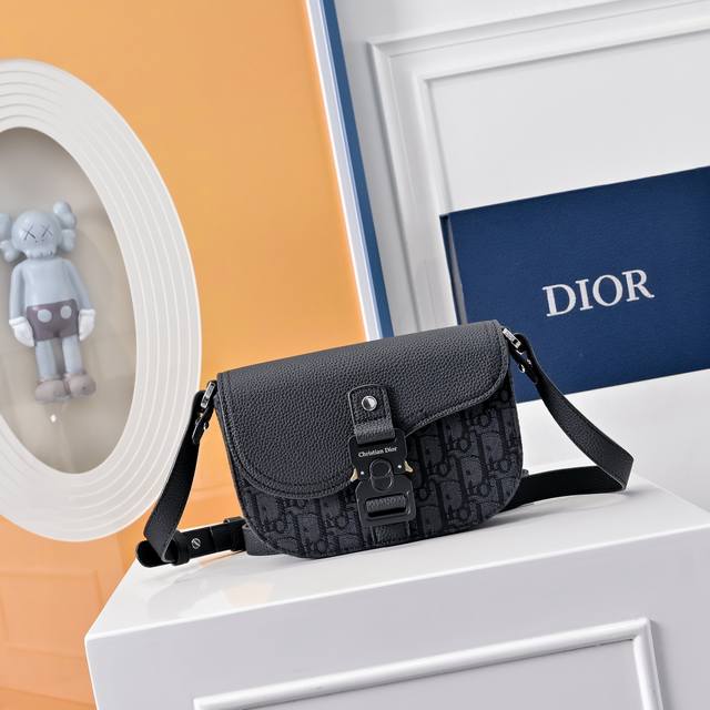 配全套折叠礼盒 这款马鞍手拿包附有肩带，是二零二三春季男装系列推出的新款单品，采用时尚的设计，彰显精致的优雅气质，为经典的马鞍系列提升格调。采用黑色粒面牛皮革精