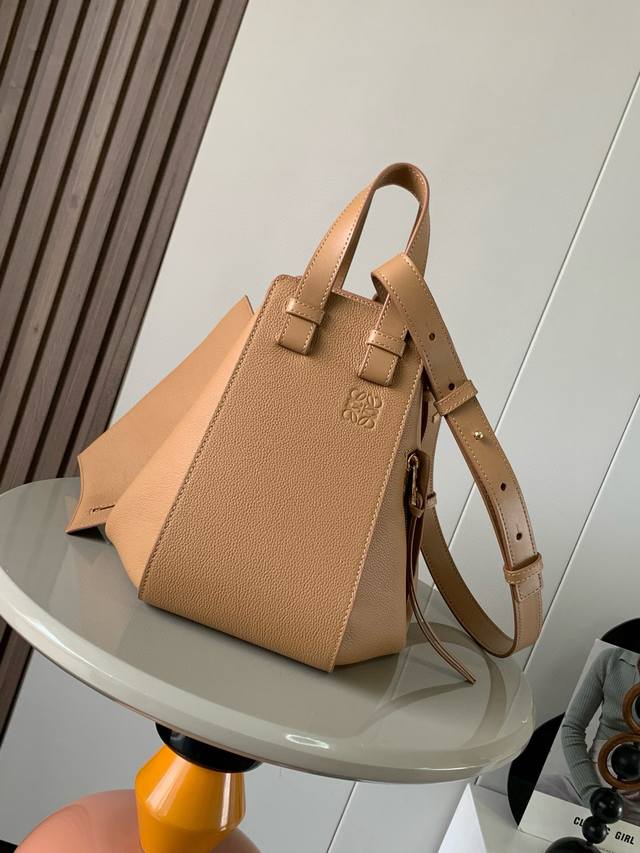 小号柔软粒面牛皮革 Hammock 手袋带有柔软侧面包身的多功能手袋可释放侧面来改变形状。环状带子可以使手袋有多种佩戴方式这个小尺寸版本采用柔软粒面牛皮革制成