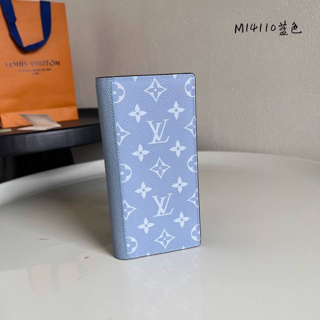 M14110 蓝色 Brazza長型錢包以色彩絢麗的Monogram塗層帆布搭配色調相襯的Taga皮革製造。精心設計的內層設有十六個信用卡夾層、拉鏈零錢格及多個