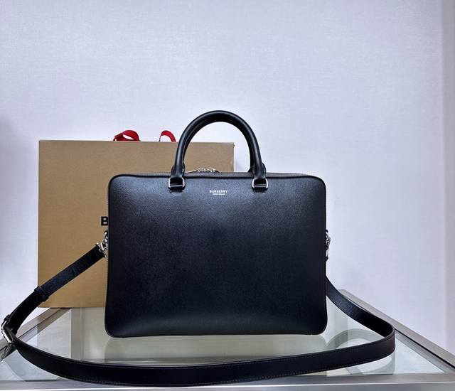 B家粒纹牛皮公文包，饰有焕新的品牌徽标。可缔造手提造型，或使用可拆式背带便于肩背。37 X 9 X 27Cm