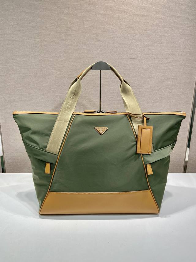 新款旅行包2Vc040 这款旅行包采用进尼龙面料，撞色小牛皮组成。巧妙容量充裕，配有可调式提手，设有大号工装侧袋与中袋，简约大气，百搭休闲，出差和平时拎用，功能