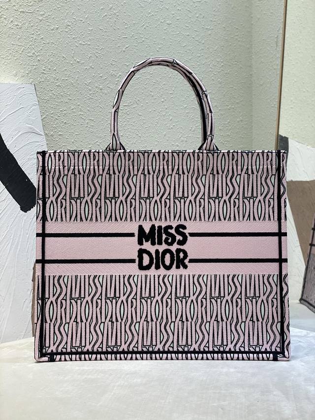 大号Book Tote 手袋 白色和粉红色Miss Dior Allover 图案刺绣 这款 Book Tote 手袋由 Dior 女装创意总监玛丽亚 嘉茜娅 大号Book Tote 手袋 白色和粉红色Miss Dior Allover 图案刺绣 这款 Book Tote 手袋由 Dior 女装创意总监玛丽亚 嘉茜娅