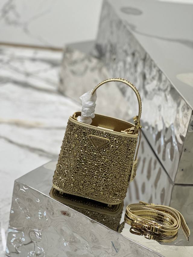 新款满天星桶包 这款优雅的Panier手袋通体覆满仿水晶，如珠宝般闪耀夺目。可拆卸肩带设计便于随心变换造型，金属徽标装饰的姓名标牌增添一抹个性。 尺寸：长15*