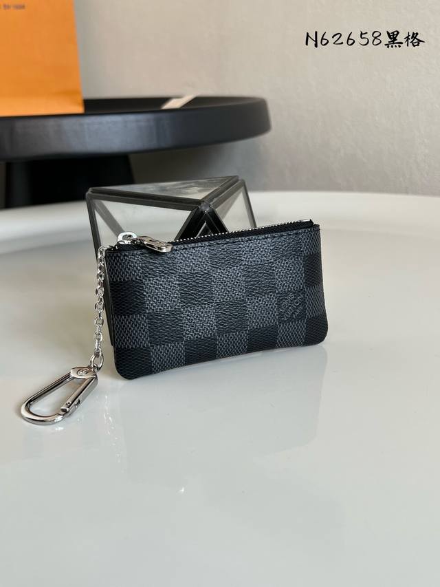 出厂价P 芯片版 N62658黑格！这款钱包让不由然想起阳光海滩的悠然，设有钥匙扣，可轻易紧扣到大部分路易威登手袋均设有的 D形环上，日常佩带，漂亮又实用。尺寸