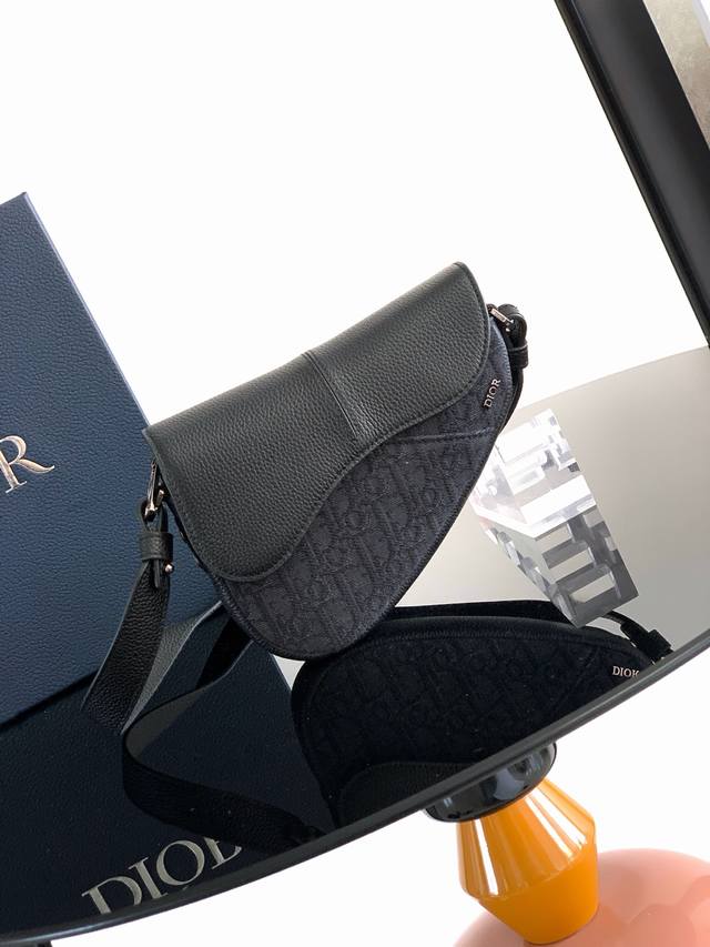 这款马鞍包以现代结构全新演绎经典设计。采用黑色 Oblique 印花面料精心制作，饰以经典的黑色粒面牛皮革磁性翻盖，搭配隐藏式拉链开合。内部设有大号隔层和插袋，