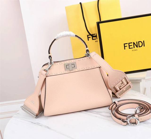 新粉色peekaboo小号手袋，全粒面皮革材质，大号手工缝线，两侧饰有经典扭锁。同色异调的全粒面皮革衬里，两个隔层由硬质隔板隔开，设有内部拉链袋和银色金属件。手