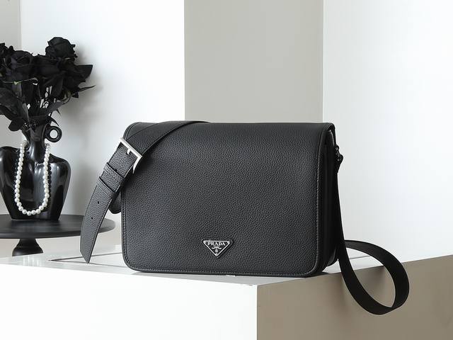 新款邮差包2Vd074 大号 这款精致多功能的单肩包采用流畅设计，由柔软牛皮革制成，具有自然触感的表面。流畅的细节强调了简单的轮廓，可调节皮革肩带，磁扣翻盖设计