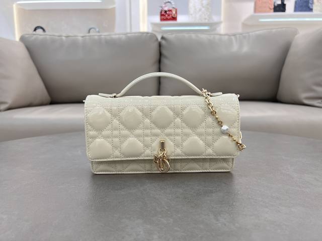 0980羊皮漆皮白色 Lady Dior 珍珠手拿包 这款手拿包是本季新品，顶部搭配手柄，优雅实用，令 Lady Dior 系列更加丰富。采用羊皮皮革精心制作，