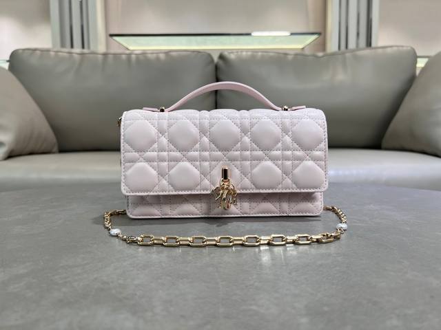 0980羊皮淡粉色 Lady Dior 珍珠手拿包 这款手拿包是本季新品，顶部搭配手柄，优雅实用，令 Lady Dior 系列更加丰富。采用羊皮皮革精心制作，饰