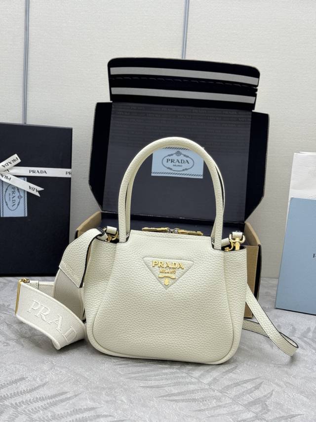 新款金扣菜篮子1Ba362迷你号 这款当代精致皮革手袋呈现天然纹理，以反向缝线设计打造柔软圆润的造型。体量小巧，既可手提，配有2条可交换长肩带，造型百变，精致优