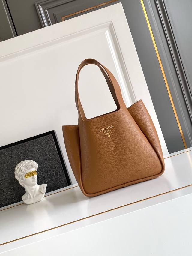 2025最新款菜篮子托特包大号 金色五金 这款皮革手袋采用解构廓形，以反向缝线诠释精美设计，打造柔和圆润的时尚造型。正面的金属字母徽标配饰尽显简约、更添轻盈、现