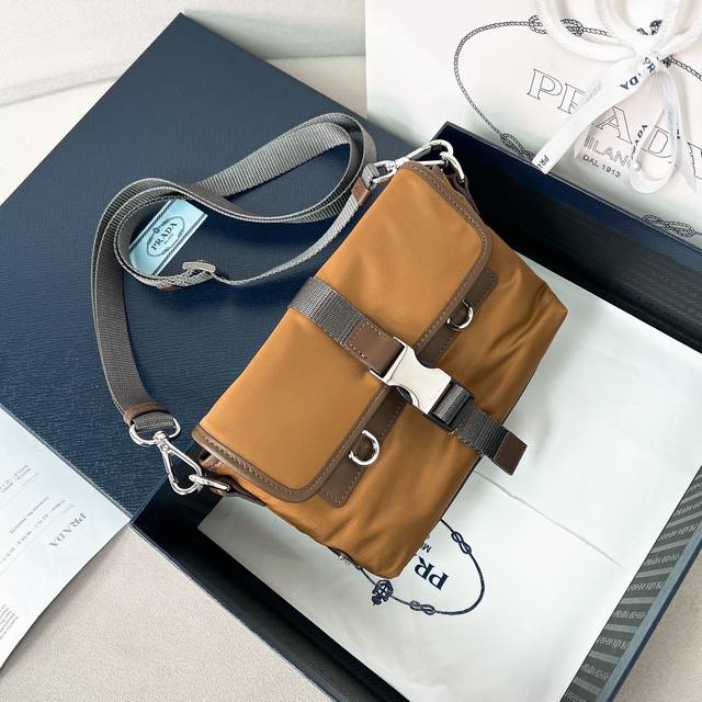 男女士手机包2Zt071拼色尼龙布2025新款牛皮革配尼龙布手机包，此款精致现代的手机包采用Re-Nylon 材质打造，配备实用卸，可调节肩带，涂珐琅金属三角形