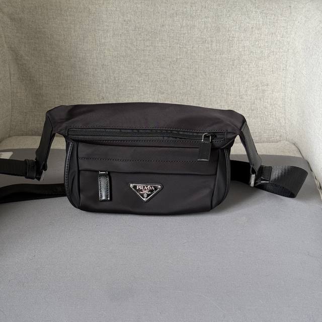 迷你邮差包2Vh171迷你 这款翻盖式单肩包采用尼龙和Saffiano皮革等标志性的p家材质制作。单肩包配有内部和外部口袋，并饰有三角形金属徽标，兼具功能性与品