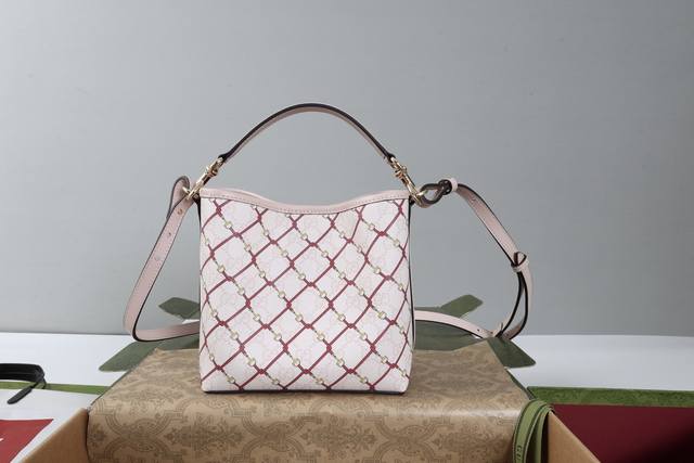 进口皮 简介：Gg Emblem系列焕新诠释品牌的隽永优雅风范和精湛工艺。这款水桶包甄选Gg字母图案涂层织物打造，搭配马镫图案，织带棉质衬里内部隔层更添实用功能