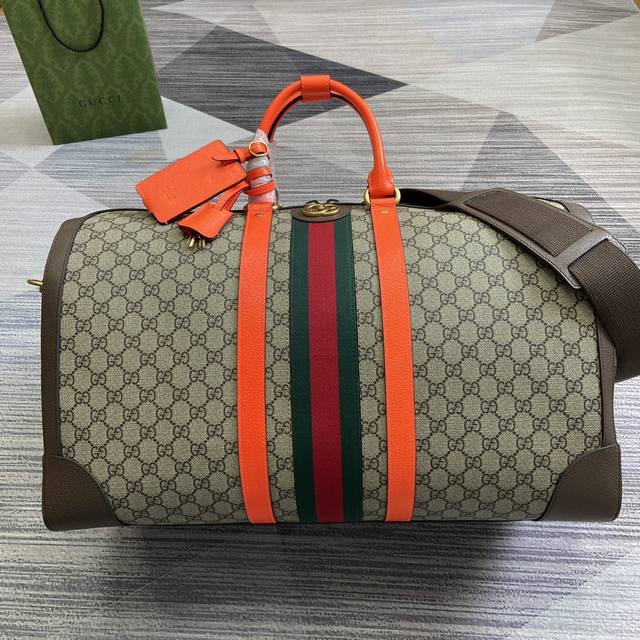 配绿色礼品袋 Gucci Savoy系列大号旅行包 Gucci Savoy系列推出全新设计旅行包，选用米色和橙色gg Supreme帆布材质，饰以品牌的标志性织 - 点击图像关闭