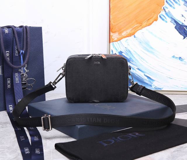 Dior 型号93310小号。 镂空皮这款手拿信使包优雅实用，可收纳各种日常用品。采用别致的黑色 Oblique Galaxy 印花效果皮革制作，镂空的光滑牛皮