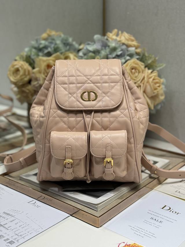 正品级 中号 Dior Caro 双肩背包 粉色 这款 Dior Caro 双肩背包是二零二五早春成衣系列新品，彰显时尚优雅风范。采用粉色羊皮革等材质精心制作，