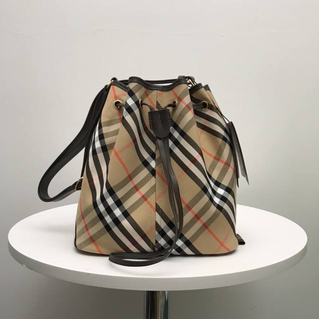 正品级 B家顶级原单 抽绳水桶包，选用棉质斜纹面料打造。于意大利工坊匠制而成，装饰精纺 Bur格纹。采用无内衬设计，质地轻盈。融入光滑小牛皮饰边，搭配可调式皮革