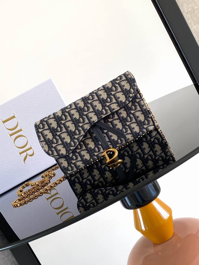 这款马鞍链条手袋采用蓝色 Oblique 印花面料等材质精心制作,巧妙融合不同元素,时尚而简约。搭配不对称翻盖,饰以复古金色饰面金属马镫 D 形吊饰。小号款式, 这款马鞍链条手袋采用蓝色 Oblique 印花面料等材质精心制作,巧妙融合不同元素,时尚而简约。搭配不对称翻盖,饰以复古金色饰面金属马镫 D 形吊饰。小号款式,