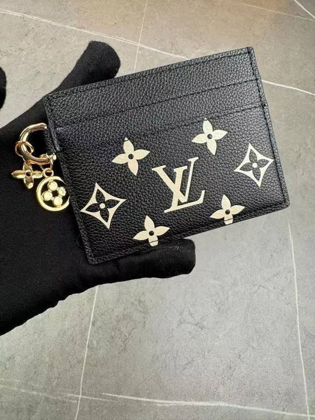 M82739 取材 Monogram 涂层帆布和牛皮革，为大号隔层两侧均衡配置卡片夹层。Monogram 花卉装饰散发莹泽光芒，成就赠礼佳选。尺寸：10.2 X