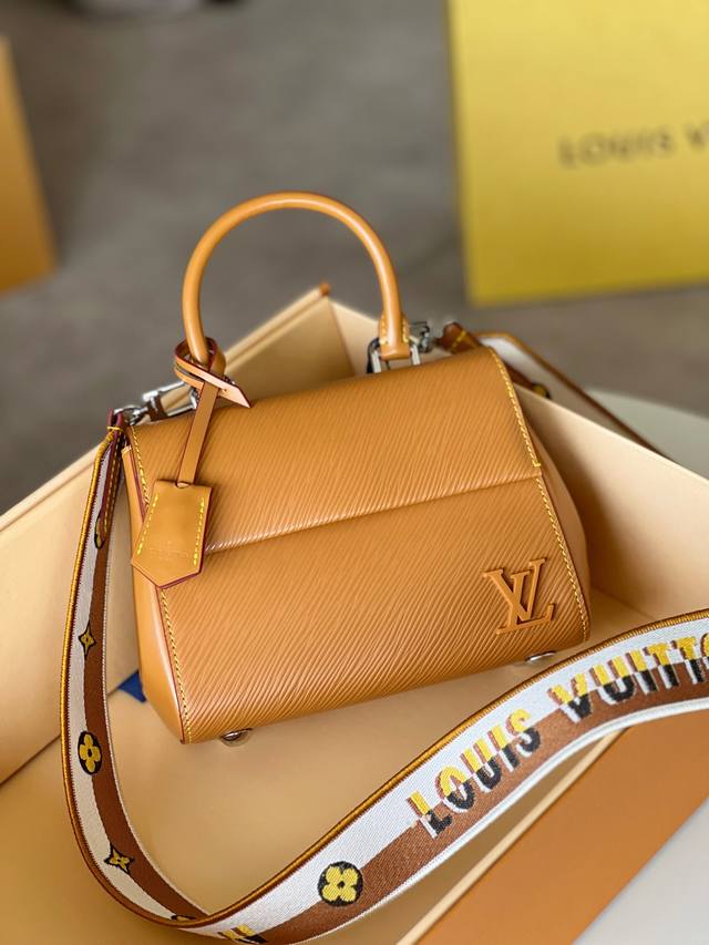 Cluny 迷你手袋 ， M58931焦糖，本款 Cluny 迷你手袋展现可拆卸提花肩带的两式风尚：路易威登标识宣示品牌身份，翻转即现 Monogram 花卉的