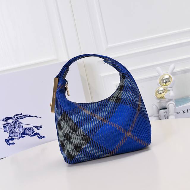 升级版 B家柔软立挺夹子包 于意大利针织打造，装饰 Burberry格纹。质地轻盈，采用无内付设计。衣夹造型挂扣镌刻 Burberry 徽标，可轻松固定弧形顶页