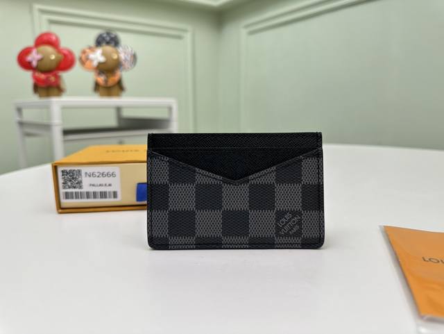 顶级原单 N62666黑格这款竖式组合卡片夹来自于时尚的 Damier Graphite 城市系列，设有两个夹层，可放置信用卡、交通卡或名片等卡片。可轻易放入上